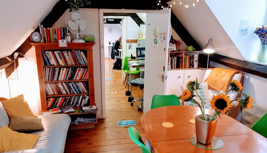 The quiet room has a sofa and  armchair, plus a dining table. And of course, bookcases.