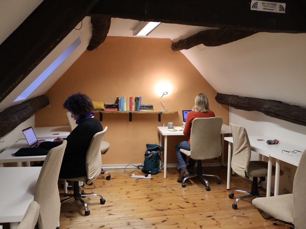 2 writers working at desks in the quiet room